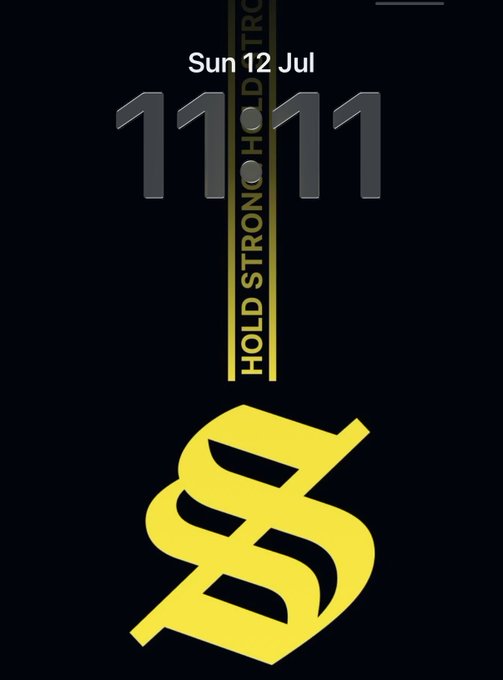 A dark phone screenshot showing a yellow dollar sign ($) and text including 'Sun 12 Jul', '11:11', and 'HOLD STRONG HOLD STRONG'.