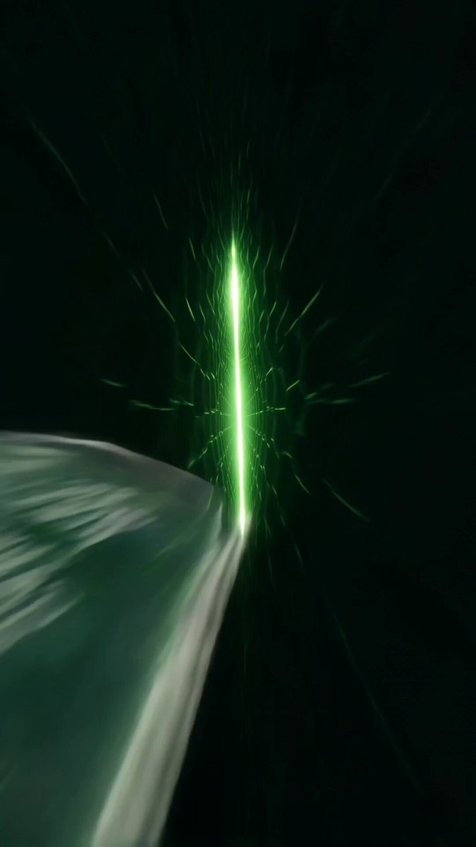 The image features a green light shining through a dark background with a white object positioned above it, creating an interesting visual effect. The bright green light appears to be coming from the top right corner of the frame, while the white object is located towards the bottom left side. This composition creates a sense of depth and draws attention to the contrasting colors in the image.