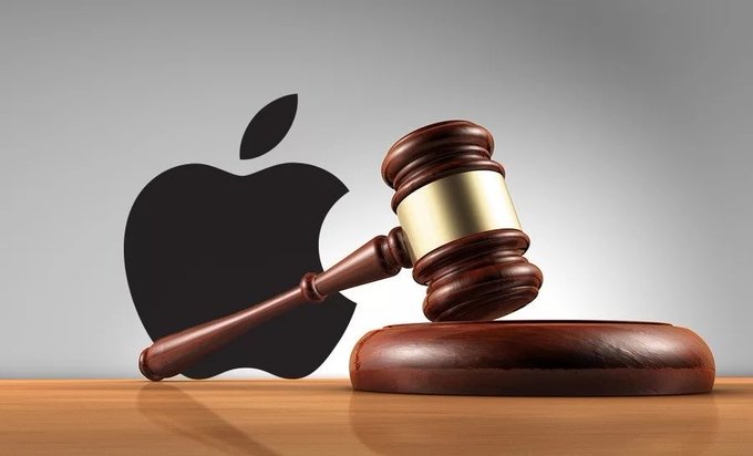 A wooden judge's gavel rests on a sounding block in front of a black Apple logo, symbolizing the lawsuit against Apple over a fraudulent Sparrow Wallet app on its App Store.