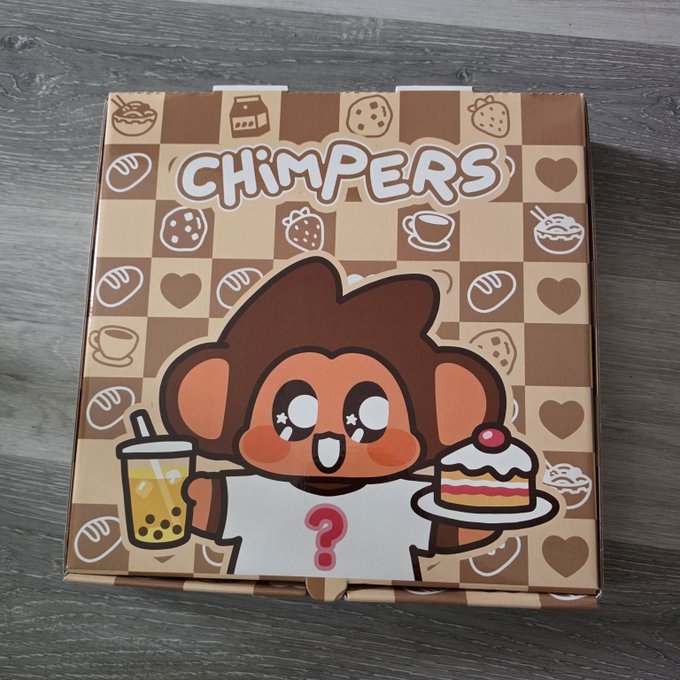 A closed cardboard box labeled 'CHIMPERS' featuring a cartoon monkey holding a bubble tea and a slice of cake, decorated with a checkered background of food and heart icons.