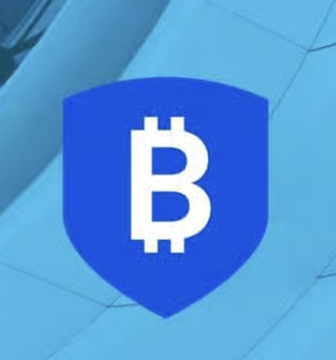 A blue shield icon with the Bitcoin "₿" symbol in white sits on a light blue background, visually representing the security and custodial aspect of cryptocurrency assets that BitGo specializes in, tying into the post about Mizuho's updated price target and rating for BitGo ($BTGO).