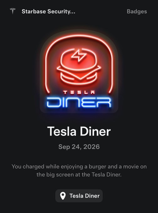 A Tesla app screenshot showing a 'Tesla Diner' badge earned on Sep 24, 2026, featuring a neon-style logo with a Tesla logo wearing a chef's hat, with text reading 'You charged while enjoying a burger and a movie on the big screen at the Tesla Diner.'