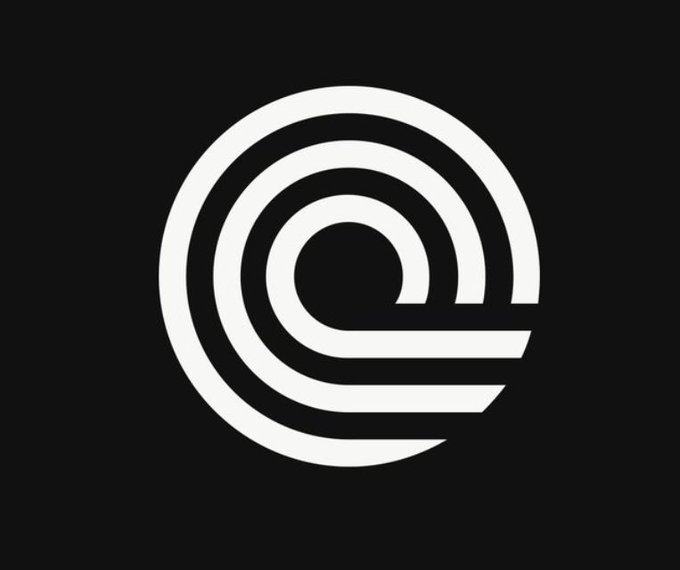 A white circular logo composed of concentric rings and a spiral design on a black background.