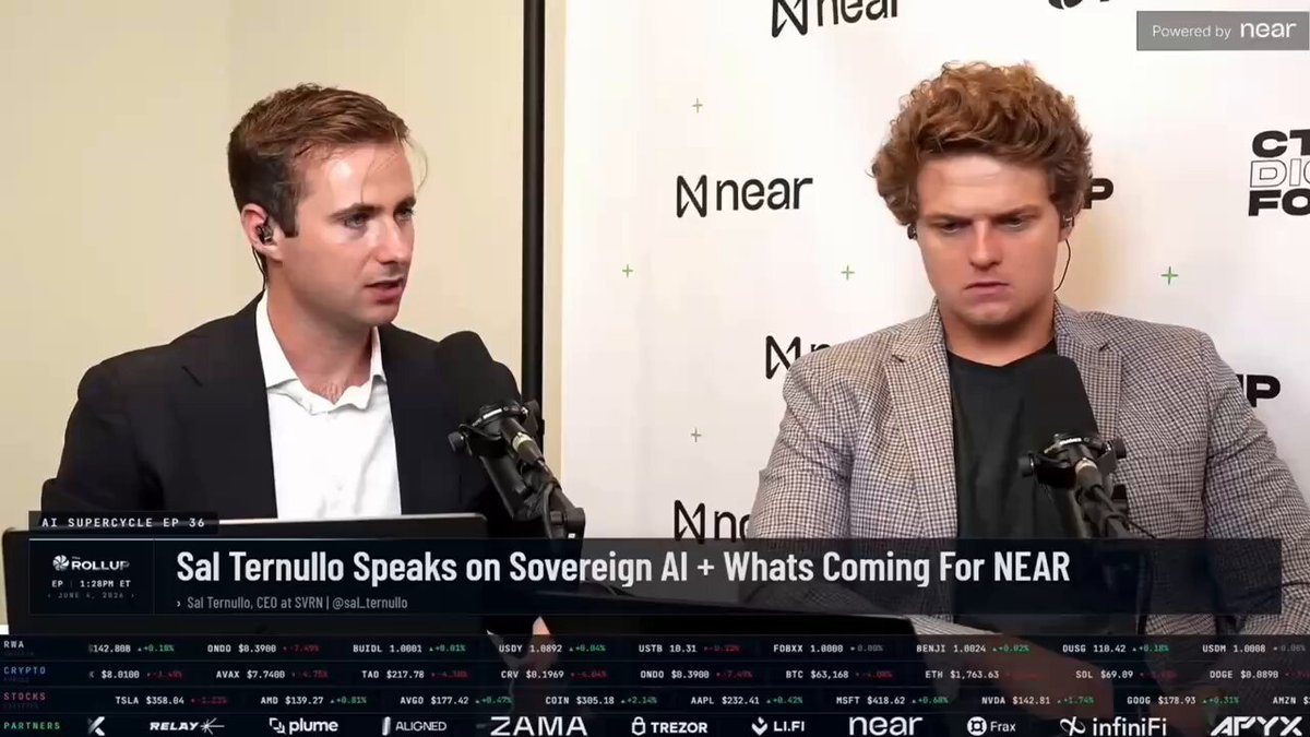 The image shows two men sitting behind microphones, with a large screen displaying text that reads "Sal Ternullo CEO at @near AI breaks down the @AI x @AskVine integration." The focus of this image is on the conversation between Sal Ternullo and another person, likely discussing the integration of AI technology.