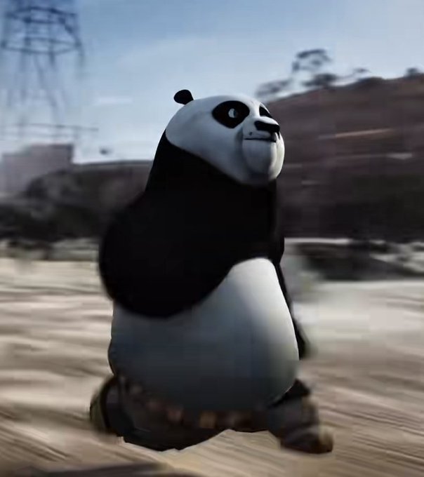 A panda, rendered in a 3D animated style similar to the Kung Fu Panda franchise, standing in an outdoor environment with blurred rocky terrain and power lines in the background.
