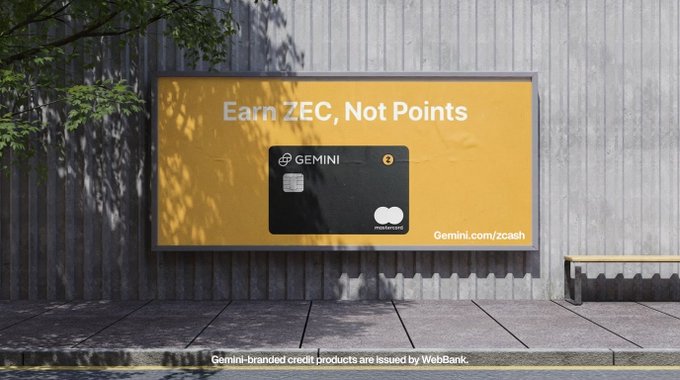 A billboard on a wooden wall advertises the Gemini credit card with the tagline "Earn ZEC, Not Points" alongside an image of the black card and the URL "Gemini.com/zcash." The ad promotes earning actual Zcash cryptocurrency rewards instead of traditional loyalty points, reinforcing the post's message that investing has become effortless and rewarding with Gemini's product offering.