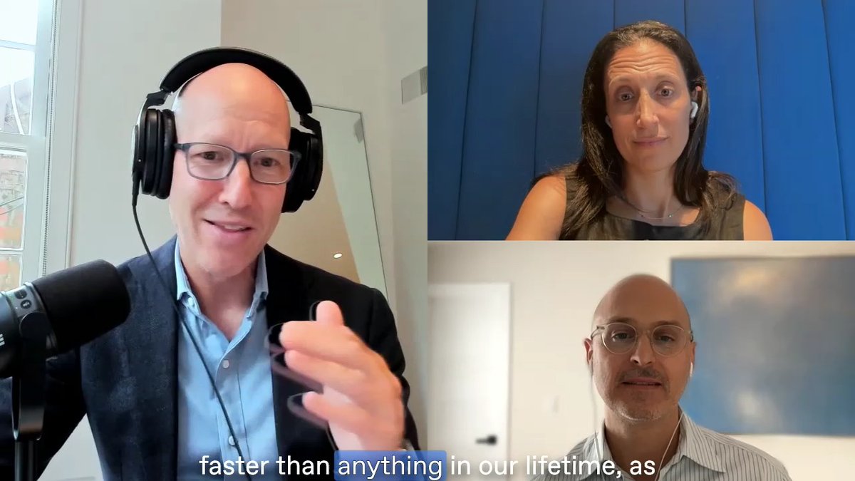 A three-way video call screenshot featuring three professionals; a bald man with headphones speaks into a microphone on the left, while a woman and another bald man with glasses listen, with subtitles reading 'faster than anything in our lifetime, as'.