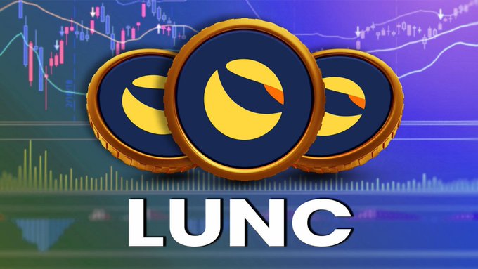 The image features a graphic design of three circular coins with a yellow center surrounded by blue, creating an artistic representation of a group of three coins that reads "LUNC" at the bottom left corner. The background of the design displays various trends on a blue gradient line and contains what appears to be financial market data in shades of pink, red, gray, black, and white. The text on the graphic includes the words "LUNC" at the center below the coins and another phrase that says "Do you think LUNC will hit $0.01 in 2026?" above it.