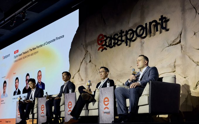 A panel discussion at an 'eastpoint' conference event with four speakers seated on stage, featuring a 'Digital Asset Treasury: The New Frontier of Corporate Finance' presentation slide on the screen.