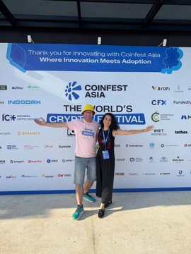 Two people posing together in front of a backdrop at CoinFest Asia, with the banner reading 'Thank you for Innovating with CoinFest Asia - Where Innovation Meets Adoption.'
