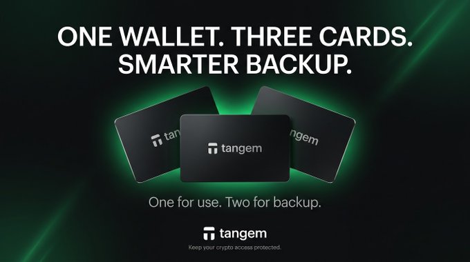 A promotional image for Tangem showing three black crypto hardware wallet cards with the text "ONE WALLET. THREE CARDS. SMARTER BACKUP."