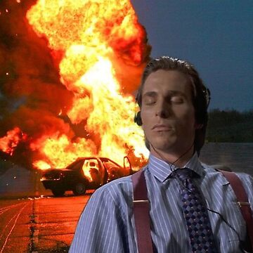 The iconic 'This is Fine' meme featuring actor Christian Bale as Patrick Bateman from American Psycho, sitting calmly in a striped shirt and suspenders while a massive explosion erupts behind him.