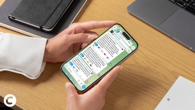 This image shows a person scrolling through the "Journal Du Coin" Telegram channel on their smartphone, which features various crypto news updates and tickers. The image visually represents the Telegram channel mentioned in the accompanying post as it celebrates reaching over 17,000 subscribers.