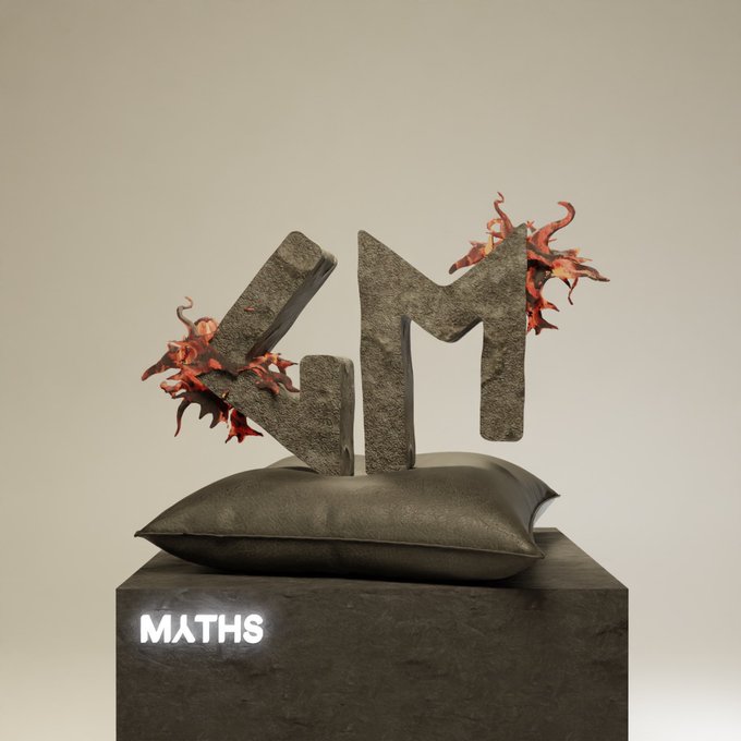 A 3D sculpture featuring the letters 'VM' in stone texture with red leaves/foliage growing from it, sitting on a dark cushion atop a pedestal labeled 'MATHS'.