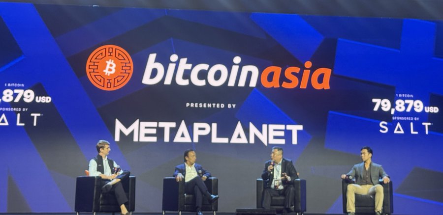 Four men sit in chairs on a stage at the 'Bitcoin Asia' conference presented by 'METAPLANET', with a Bitcoin price display showing 79,879 USD sponsored by SALT.