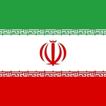 The image shows the flag of Iran, featuring horizontal green, white, and red stripes with the red national emblem centered on the white band and stylized Kufic script along the borders separating the colors. This flag relates to the post about a US Senate investigation revealing that 84% of wallets sanctioned over Iran ties conducted transactions predominantly in Tether's USDT, highlighting the use of cryptocurrency to evade sanctions imposed on the country.