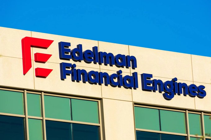 The image shows the exterior of a building with a large sign reading "Edelman Financial Engines" accompanied by a red logo, set against a clear blue sky. This visual directly supports the accompanying text highlighting Edelman Financial Engines, a top U.S. retirement and asset management company, which indirectly holds approximately $49 billion worth of Bitcoin through its 401(k) services, marking another positive accumulation factor for Bitcoin.
