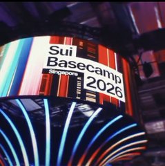 A digital display showing 'Sui Basecamp Singapore 2026' at an event with colorful vertical light strips.