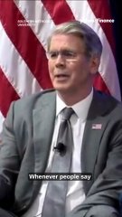 A man in a suit speaking at a podium with American flags in the background, with the subtitle "Whenever people say" and a channel logo at the top.