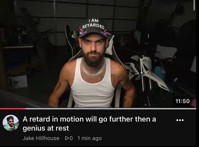 A YouTube video screenshot of a bearded man wearing a hat that says 'I AM RETARDED' and a white tank top, with a comment below reading 'A retard in motion will go further then a genius at rest' by Jake Hillhouse.