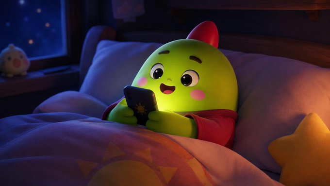 A 3D-rendered illustration of a cute green cartoon character with rosy cheeks wearing a red hoodie, lying in bed under a star-patterned blanket while smiling at a smartphone showing a sun icon, in a cozy nighttime bedroom setting.