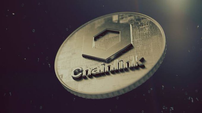 Close-up of a metallic Chainlink (LINK) cryptocurrency coin with its hexagonal logo, set against a dark background with digital particles.