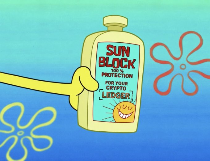A SpongeBob-style cartoon image shows a yellow hand holding a bottle of 'SUN BLOCK' advertised as '100% PROTECTION FOR YOUR CRYPTO LEDGER' with a smiling sun graphic.