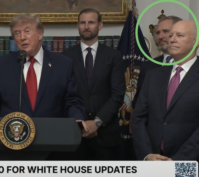 President Trump speaks at a podium in the White House, flanked by officials, including Brad Garlinghouse who is circled in green, as indicated by the accompanying post. The bottom of the image shows text that appears to be a news ticker related to White House updates.