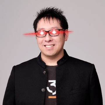 A man wearing a black jacket and glasses with red laser beams emitting from the lenses smiles at the camera.