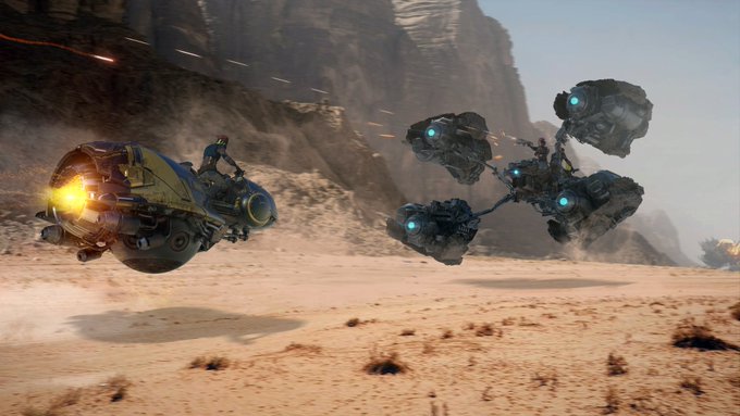 A racing pod with a fiery thruster navigates a desert landscape while being pursued by a multi-engine mechanical opponent. The image visually captures the high-speed, competitive nature of "Racing pods" as described.