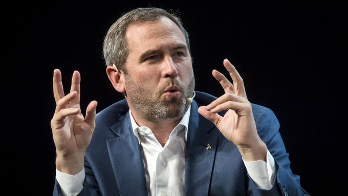 Brad Garlinghouse, CEO of Ripple, gestures expressively while speaking at an event, his animated hand movements complementing the viral messaging about Ripple's XRP strategy and commitment to blockchain innovation that has drawn renewed attention amid ongoing regulatory discussions with the SEC.
