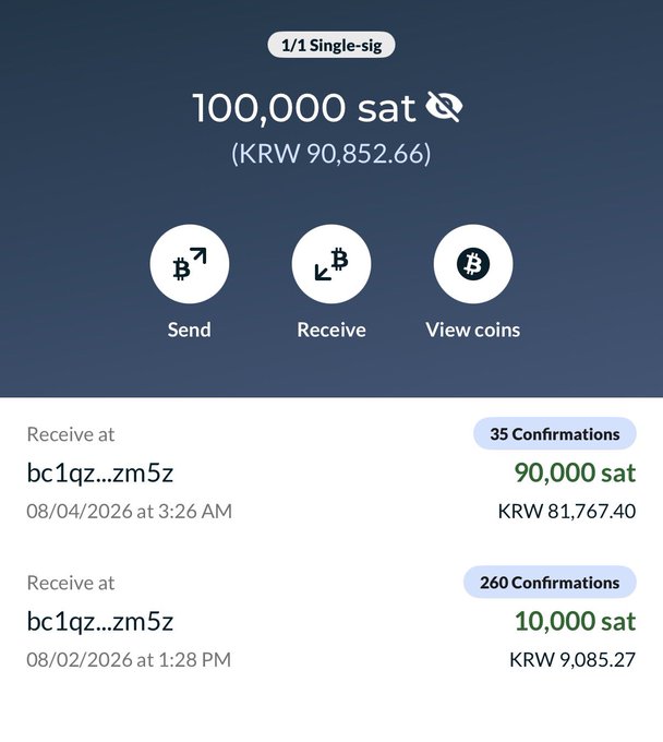 A mobile Bitcoin wallet interface displays a balance of 100,000 sat (KRW 90,852.66) in a 1/1 Single-sig account, showing two recent incoming transactions of 90,000 sat and 10,000 sat from the address bc1qz...zm5z with 35 and 260 confirmations respectively. This corresponds to the "bait" transaction referenced in the post about the ColdcardQ Auto-Generated Seed Experiment waiting 260 blocks (43 hours).