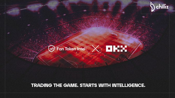 The image is a promotional graphic featuring a red-tinted aerial view of a crowded football stadium, overlaid with the logos for "Fan Token Intel" and "OKX," alongside the OKX logo in the top right corner. The bold tagline "TRADING THE GAME. STARTS WITH INTELLIGENCE." appears at the bottom. This visual aligns with the post by announcing the integration of Fan Token Intel into the OKX AI Agent Marketplace, symbolizing the merging of AI-driven match intelligence with the energy of live sports.