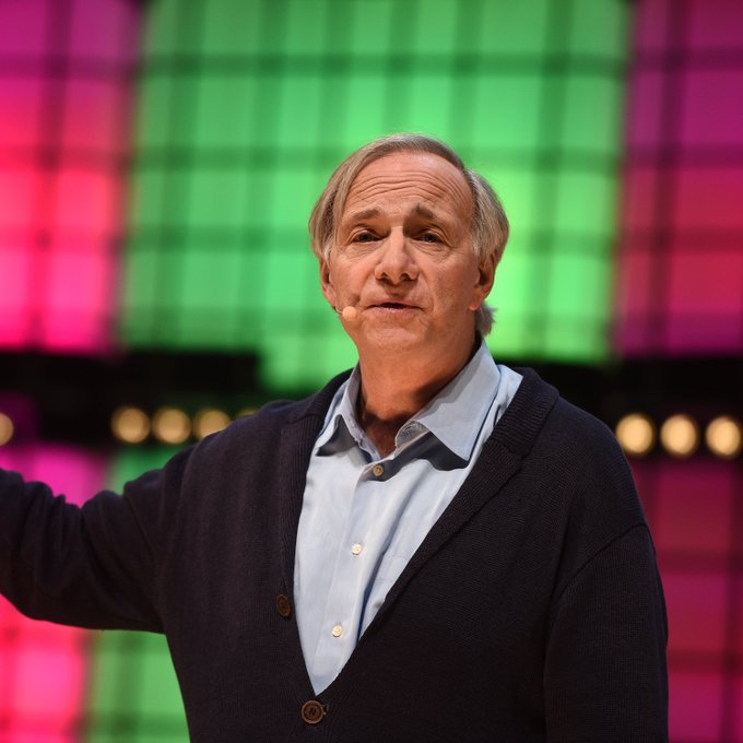 Ray Dalio, the billionaire founder of Bridgewater Associates, appears on stage during what seems to be a speaking engagement, providing context to his recent warning about a potential U.S. debt crisis within three years given the country's $2 trillion annual deficit.