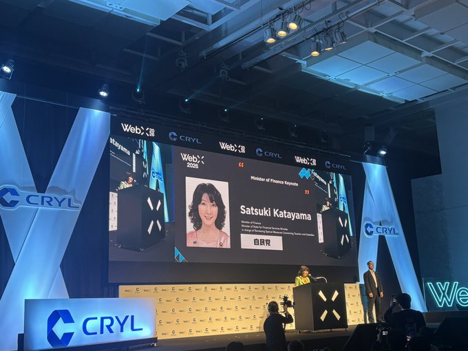 A conference stage with 'CRYL' and 'WebX' branding displays a slide featuring Satsuki Katayama, Minister of Finance, with the title 'WebX 2025' visible on screen.