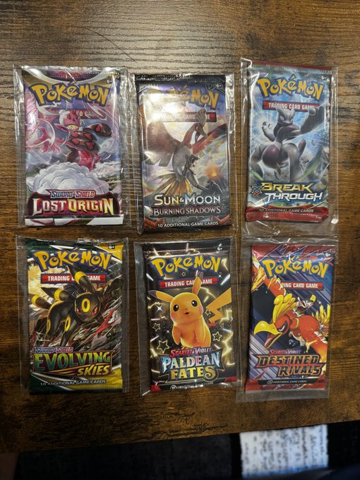 Six sealed Pokémon Trading Card Game booster packs including Lost Origin, Burning Shadows, Break Through, Evolving Skies, Paldean Fates, and Destined Rivals.