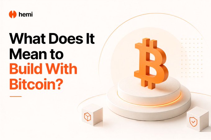 The image is a promotional graphic from Hemi featuring the headline "What Does It Mean to Build With Bitcoin?" alongside a stylized orange Bitcoin "B" logo on a pedestal, with small cube icons below—one displaying a Bitcoin symbol—visually representing the concept of building blockchain applications directly on Bitcoin's network rather than typical EVM platforms.