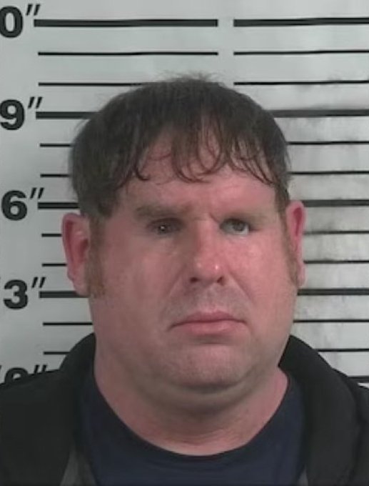 This image appears to be a mugshot of a middle-aged man with short brown hair, standing in front of a height chart background. The accompanying text mocking "mouth breathers" who believed in a "4 year cycle" seems to humorously suggest the man's disheveled appearance exemplifies someone who may have made poor predictions, though no names or specific text identifying him are visible in the image.