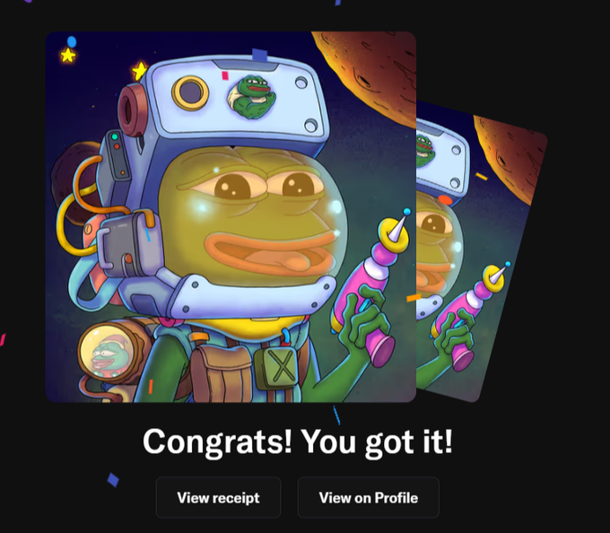 The image features a cartoon character, possibly an alien or a frog, wearing a helmet with a camera attached to it. The character appears to be holding a camera as well. The background of the image shows a planet, suggesting that this scene takes place in outer space. The caption reads "Congratulations! You got it!", indicating that the viewer has successfully completed a challenge related to the cartoon character or the post itself.