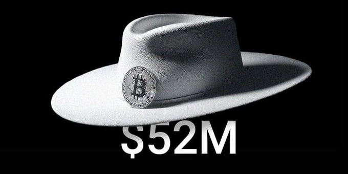 A white cowboy hat featuring a Bitcoin medallion on a black background, with the text "$52M" displayed below.