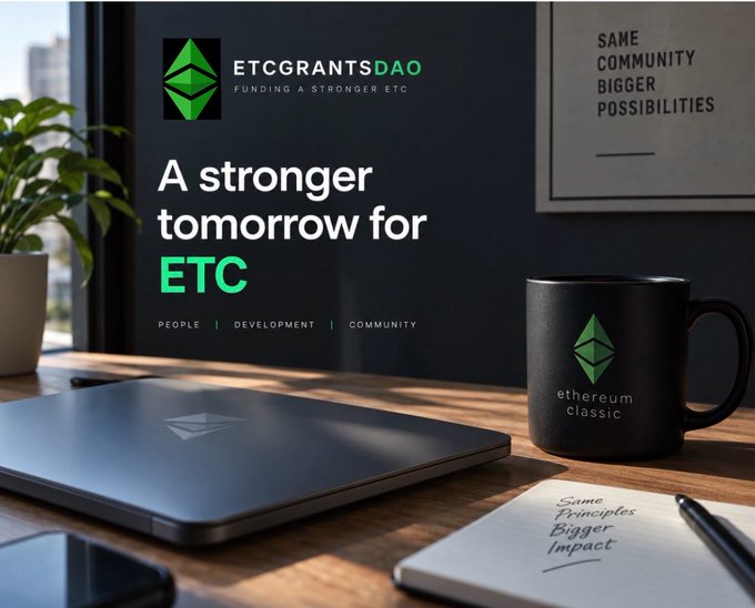A promotional graphic for 'ETCGRANTSDAO' featuring the Ethereum Classic logo, with text reading 'A stronger tomorrow for ETC' and 'FUNDING A STRONGER ETC', alongside a laptop with the logo, a black mug reading 'ethereum classic', and a notebook titled 'Some Principles, Bigger Impact'.