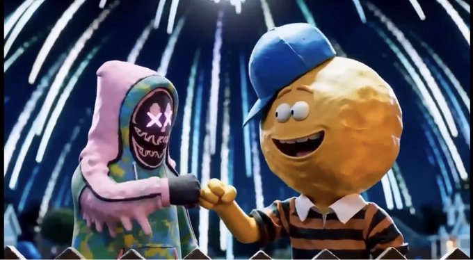 A 3D-rendered scene showing a smiling yellow lemon-headed character with a blue cap fist-bumping a hooded figure with X eyes and a stitched grin, against a background of fireworks.
