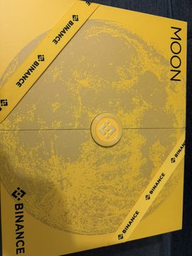 A yellow Binance-branded Moon envelope with the Binance logo prominently displayed around the edges.