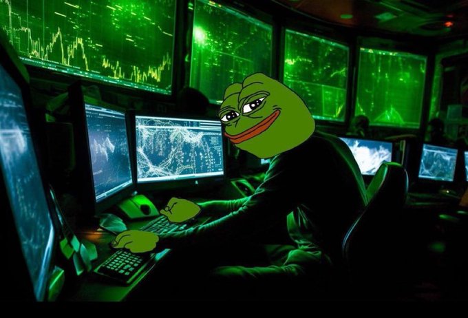 A Pepe the Frog character wearing a black hoodie sits at a desk with a keyboard, surrounded by multiple monitors displaying green-tinted stock market charts and trading data.