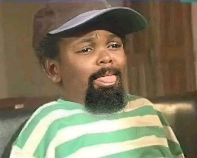 A man with a sideways baseball cap and striped shirt gives a skeptical side-eye, as if unsure the "iPhone 18" mentioned is really worth the cost his balance can't handle.