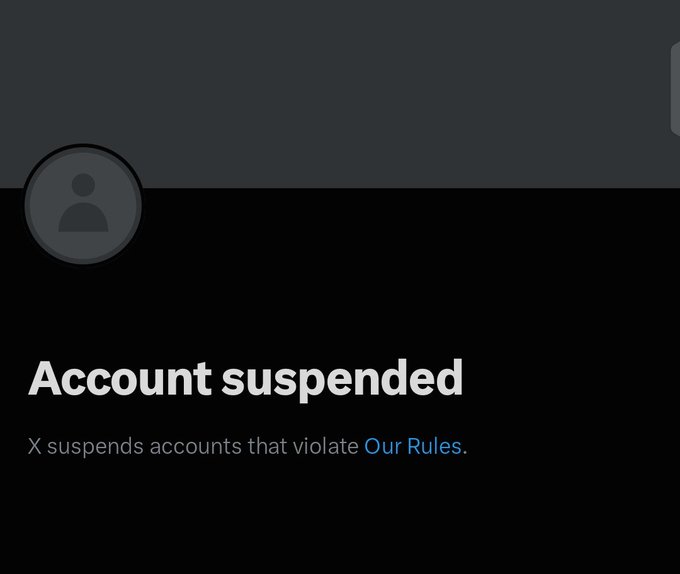 A screenshot of X (formerly Twitter) showing a default profile avatar and the message "Account suspended - X suspends accounts that violate Our Rules." The image confirms the suspension of the account @devmustee mentioned in the post, with the user sarcastically thanking X and their "reply guys" for the suspension.