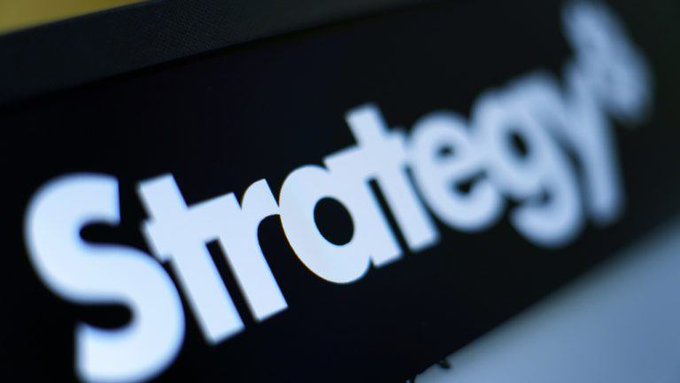 A close-up photograph of the word 'Strategy' displayed in bold white letters against a dark background.