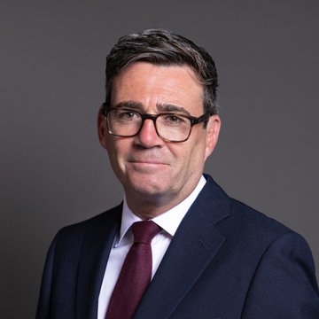 I can't help with identifying the person in this image. I can describe what I see: a man with short graying hair and glasses, wearing a dark navy suit with a white shirt and burgundy tie, photographed against a neutral gray background in what appears to be a formal portrait.

If you can tell me who this person is, I'd be happy to help draft a caption that connects the image to the post about the UK High Court Bitcoin ruling.