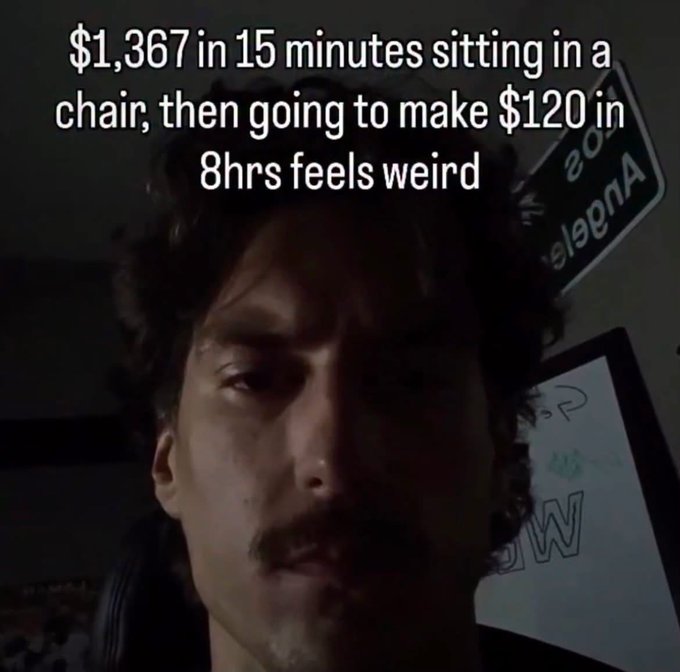 A man with curly hair and a mustache with text overlay reading '$1,367 in 15 minutes sitting in a chair, then going to make $120 in 8hrs feels weird'.