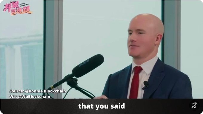 A bald man in a blue suit and red tie speaks into a microphone, with the subtitle 'that you said' and Chinese text '崩屎巨佬讲' in the upper left corner.